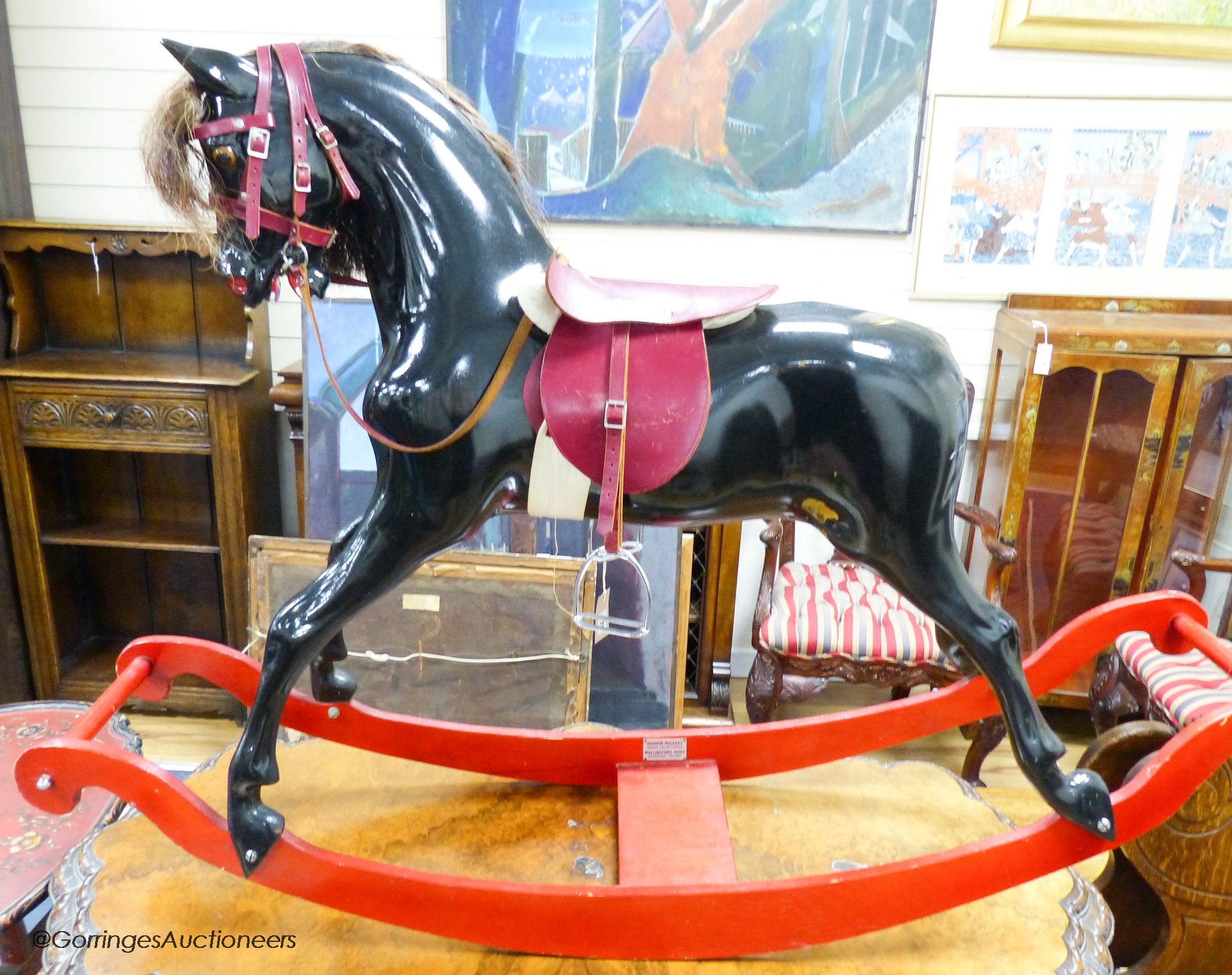 A fibre glass rocking horse, 151 cm long, 101 cm high